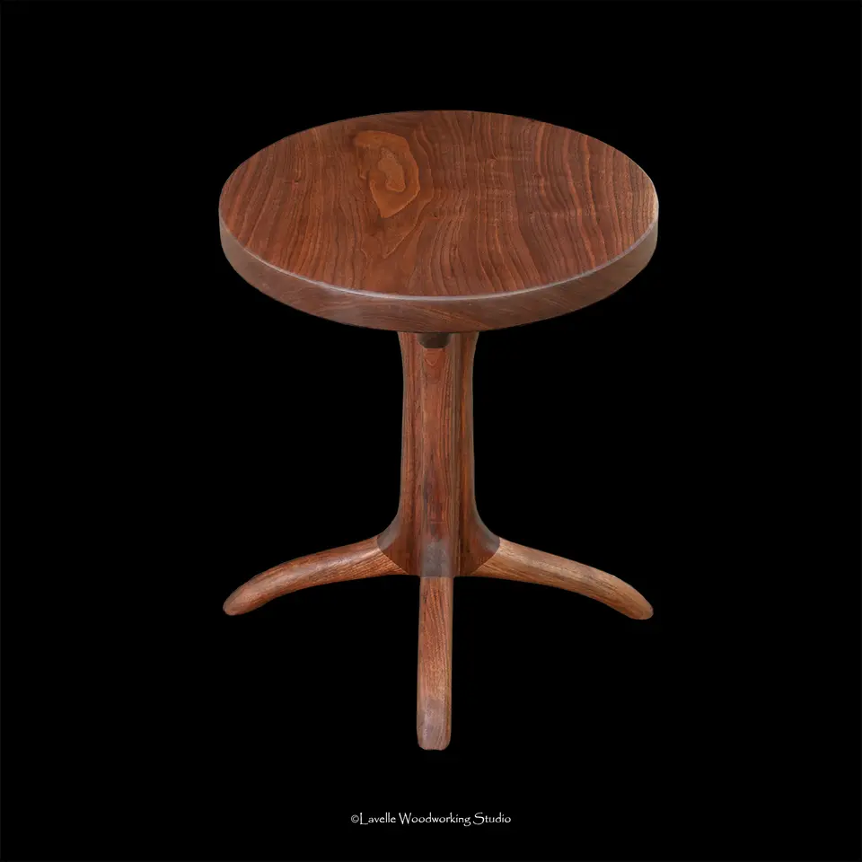 Miranda Side Table Round in walnut on a hand-shaped three-footed base